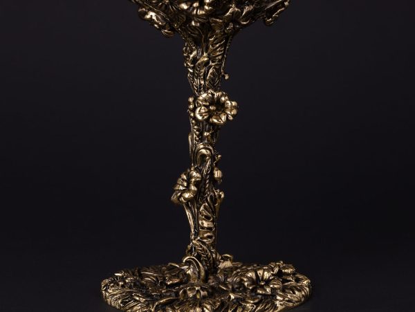 Elegant glass with ornate golden base