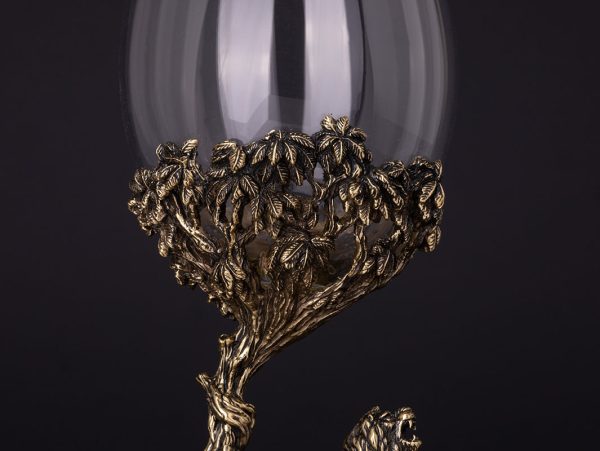 Bronze lion sculpture with tree